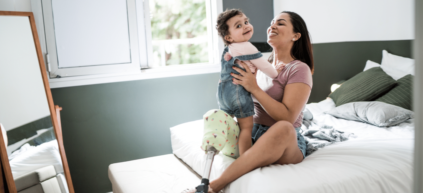 Women with prosthetic leg holding her child
