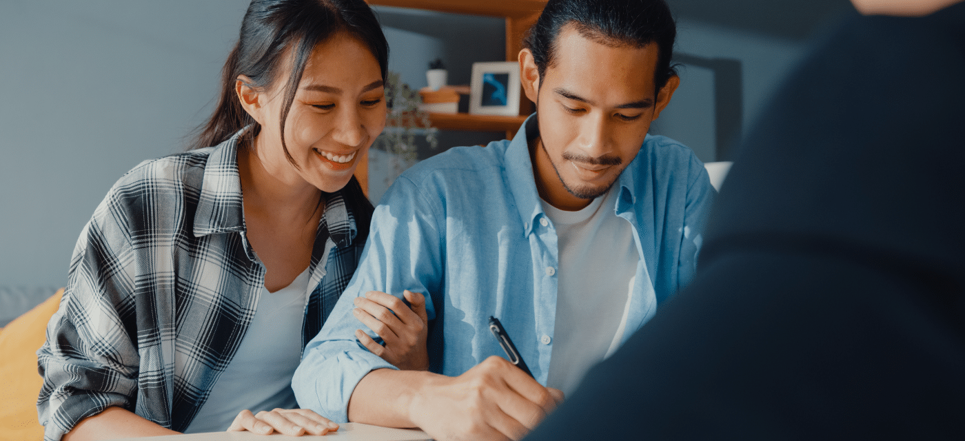 Couple signing documents