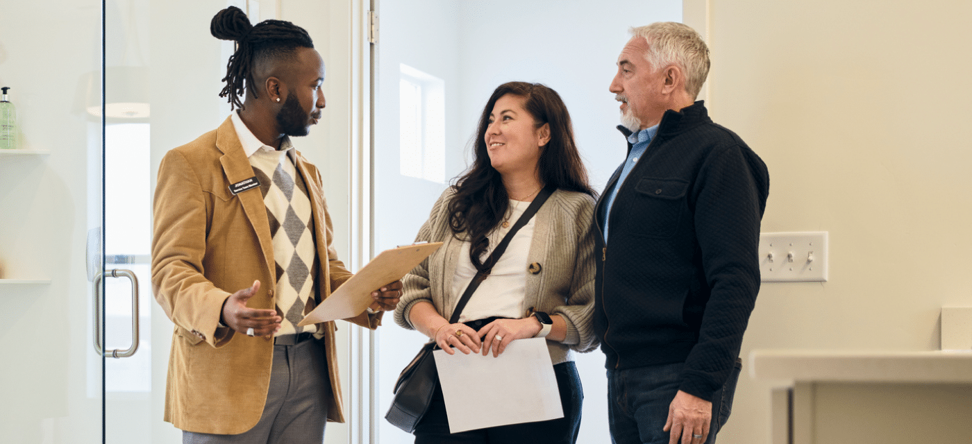 Business man talking with two clients in office building