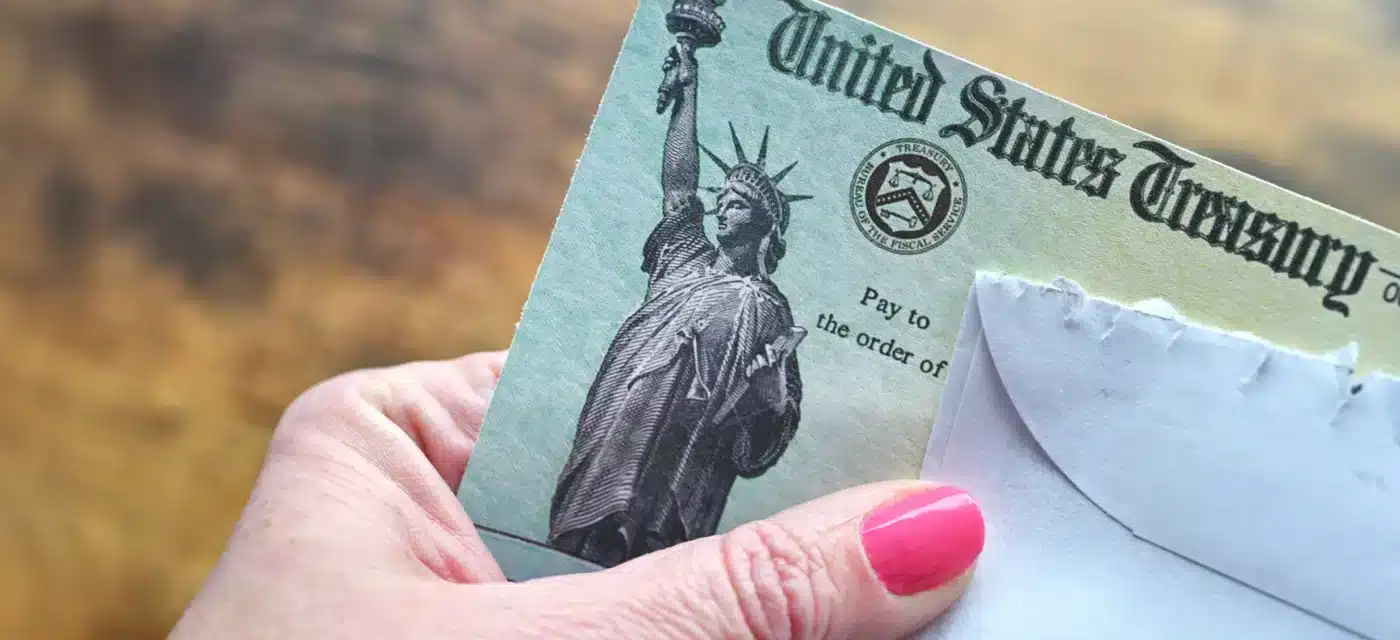Person holding paper check from the government