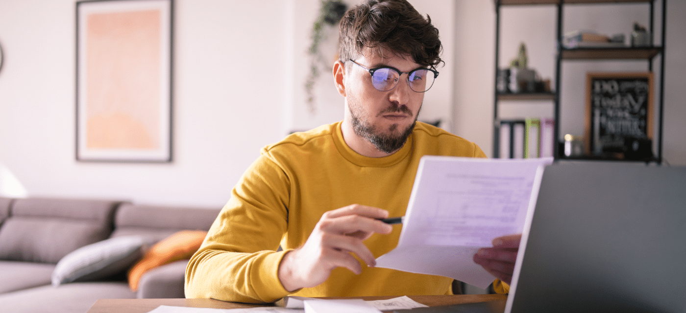 Man reviewing a document at his desk