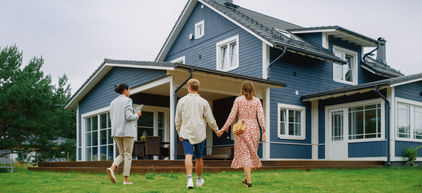 Couple walking up to a home with a real estate agent