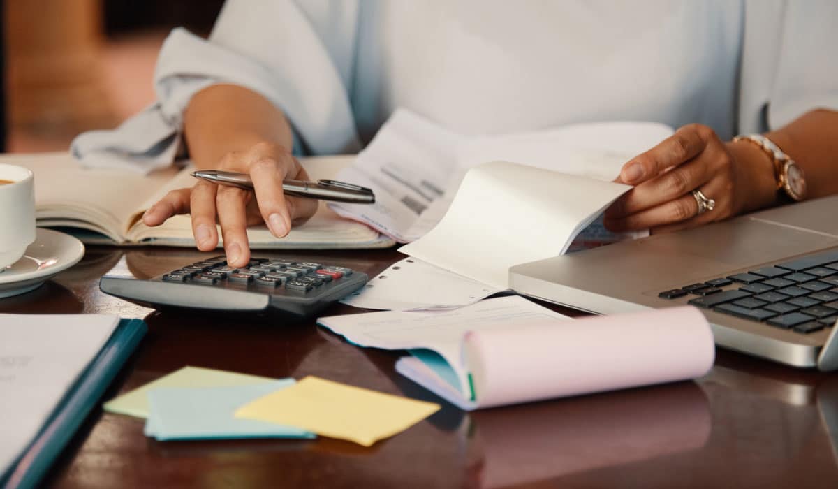 A woman using a calculator.