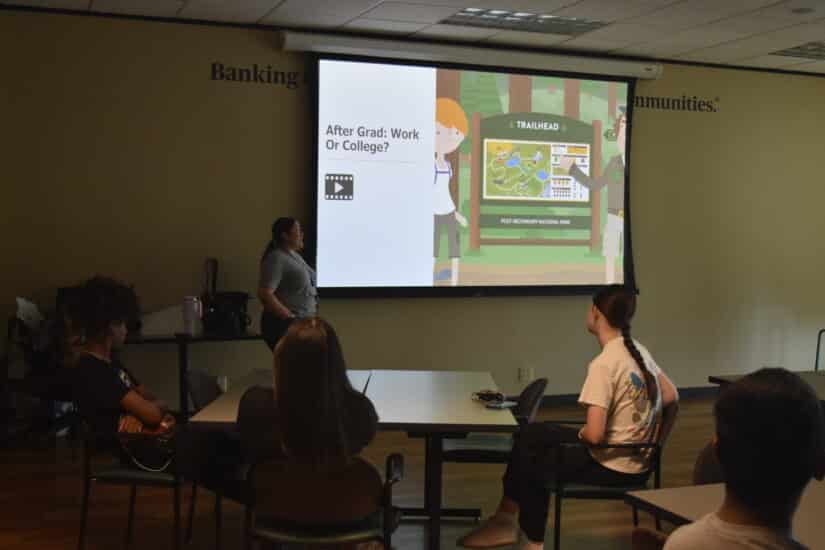 Camp facilitator talking to campers about options after graduation and paying for college.