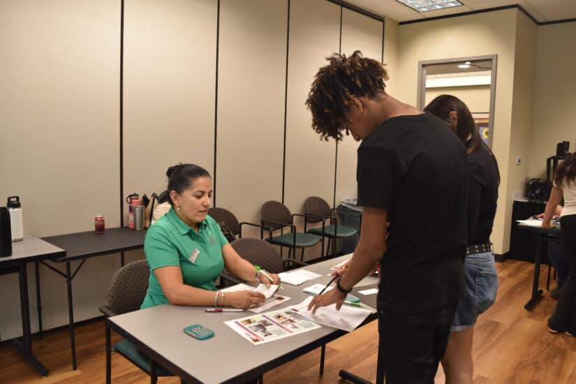 Camper buying household items during the Mad City Money budgeting simulation.