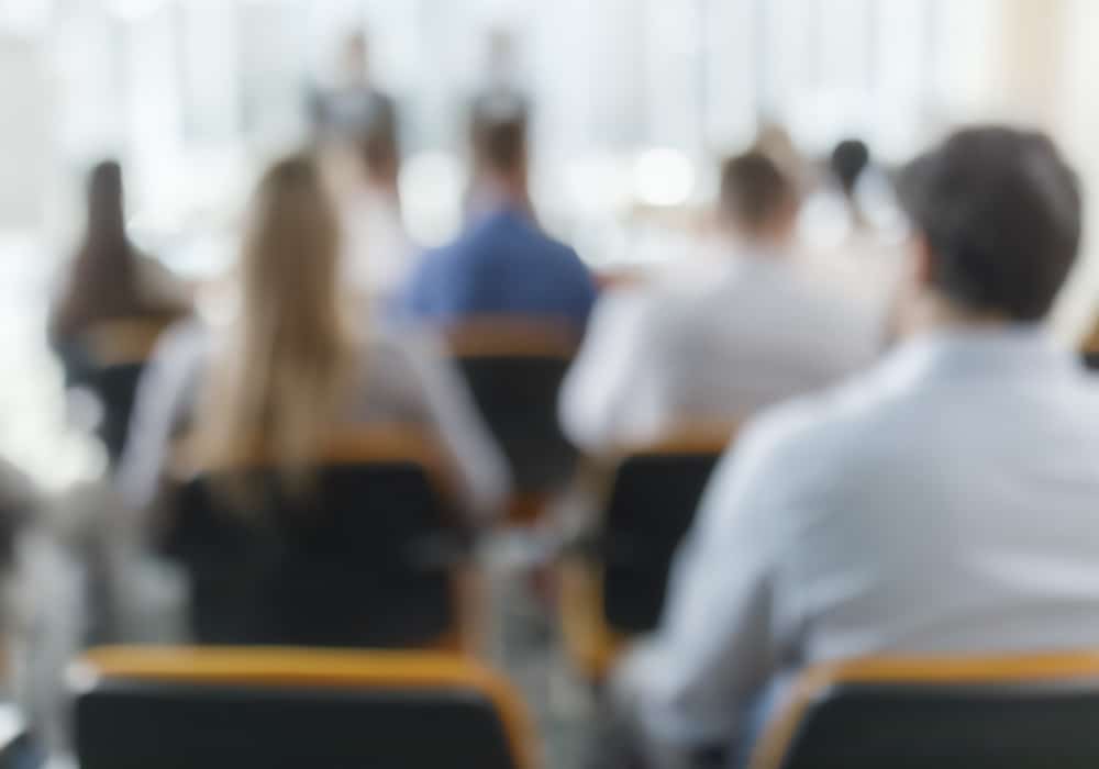 Audience members seated in front of speaker