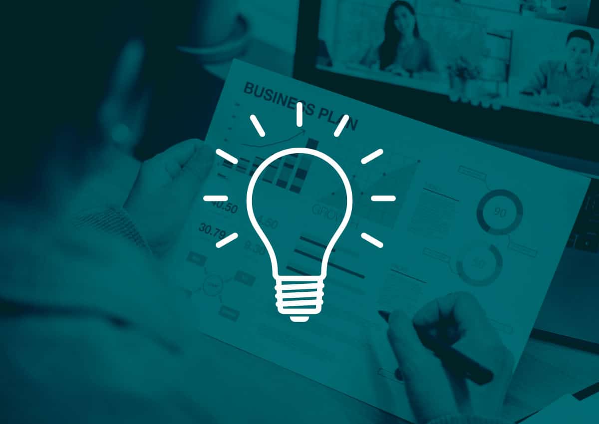 Light bulb icon over an image of someone reviewing a business plan