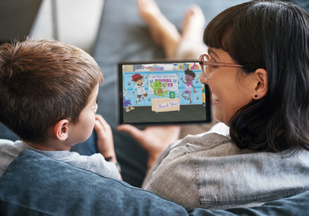 A woman and a young boy watching a cartoon on an Ipad.