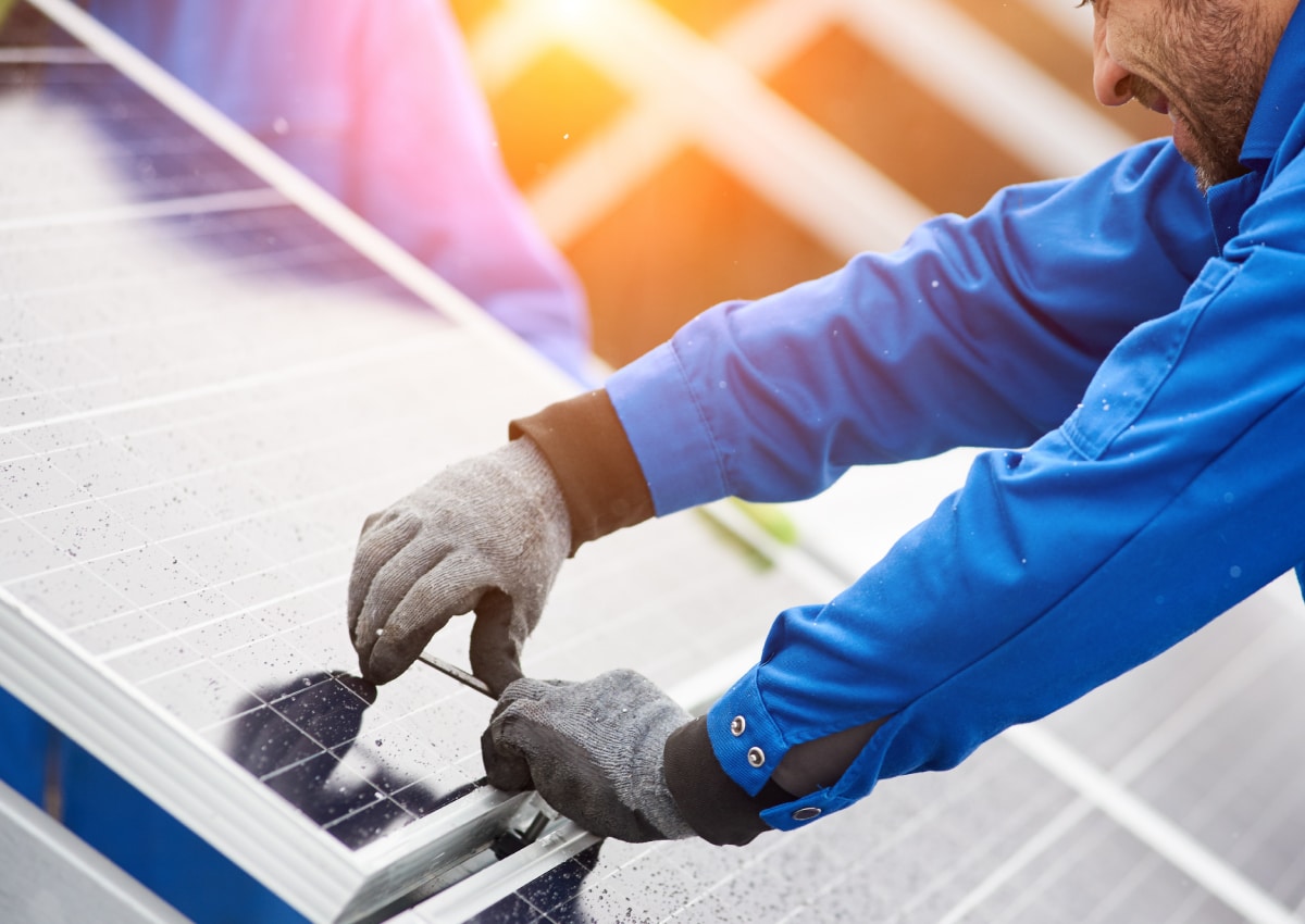 Hands installing solar panels
