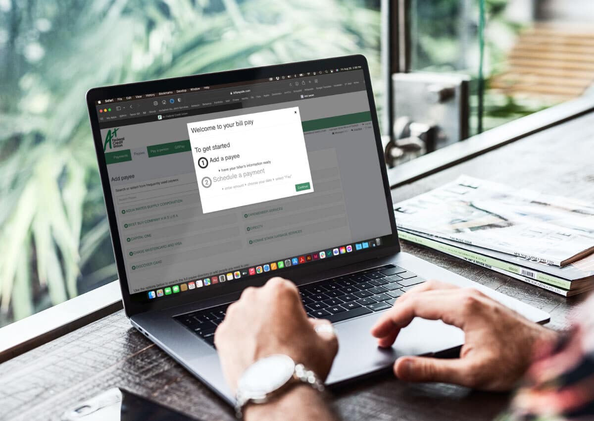 Someone using a laptop to use A+FCU Bill pay.