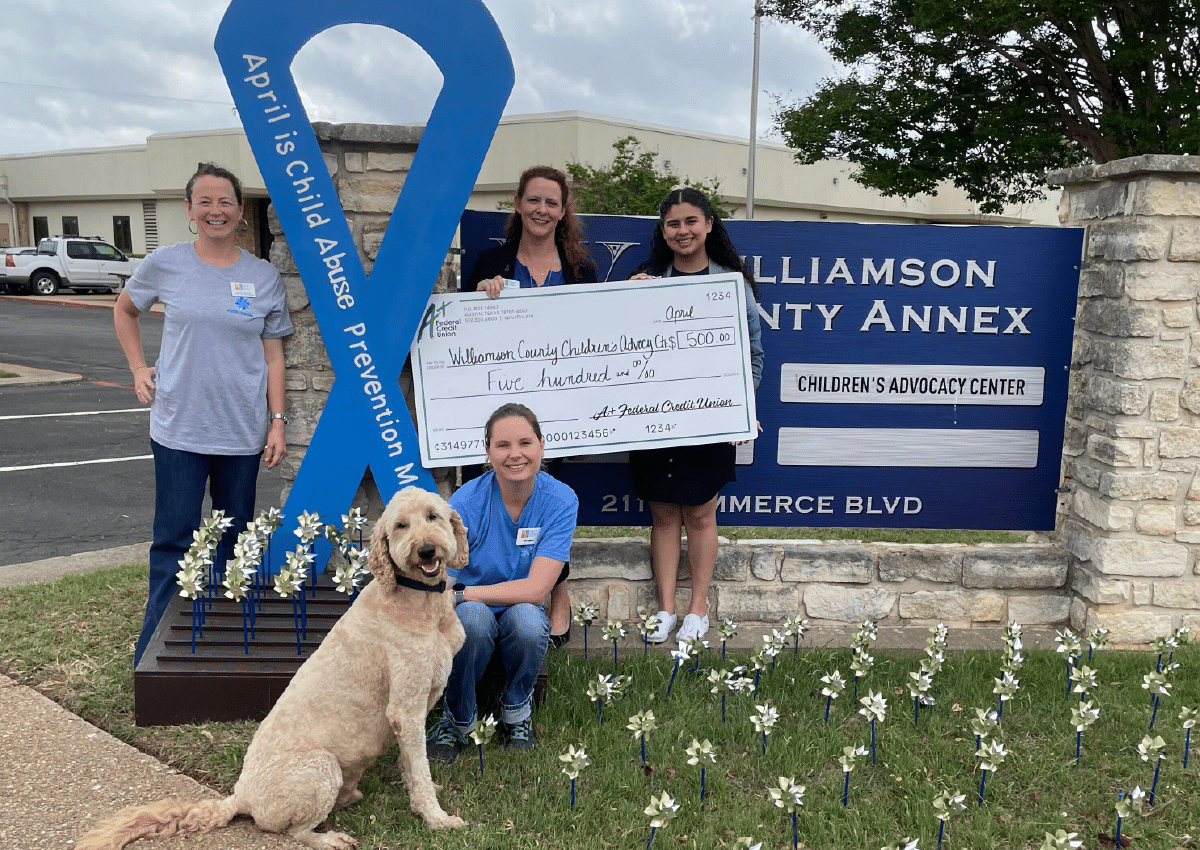 A+ Staff giving a check to the Children's Advocacy Center.