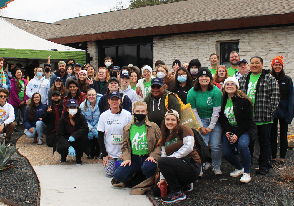 Large group of A+ Team members and other volunteers posing at the water station