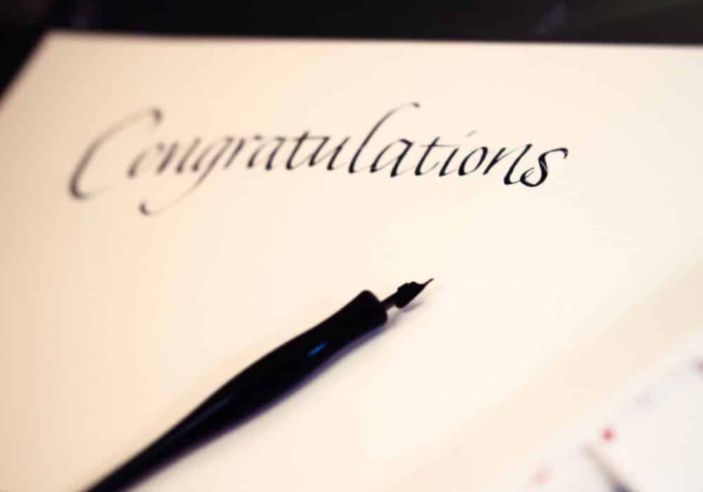 Congratulations written on a piece of paper in ink.