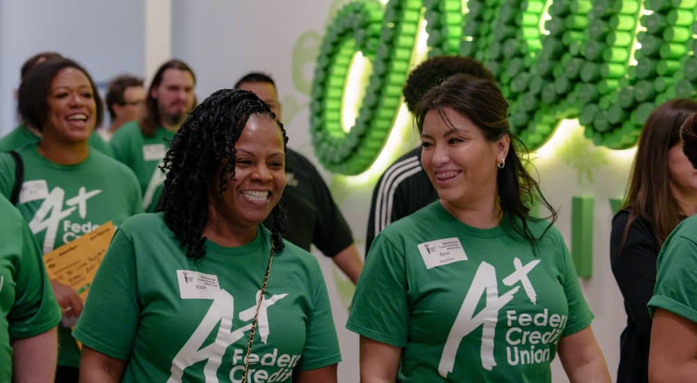 A+ volunteers laugh while walking through the Central Texas Food Bank.