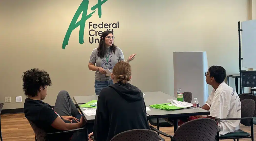 Camp Counselor talks to campers about finances