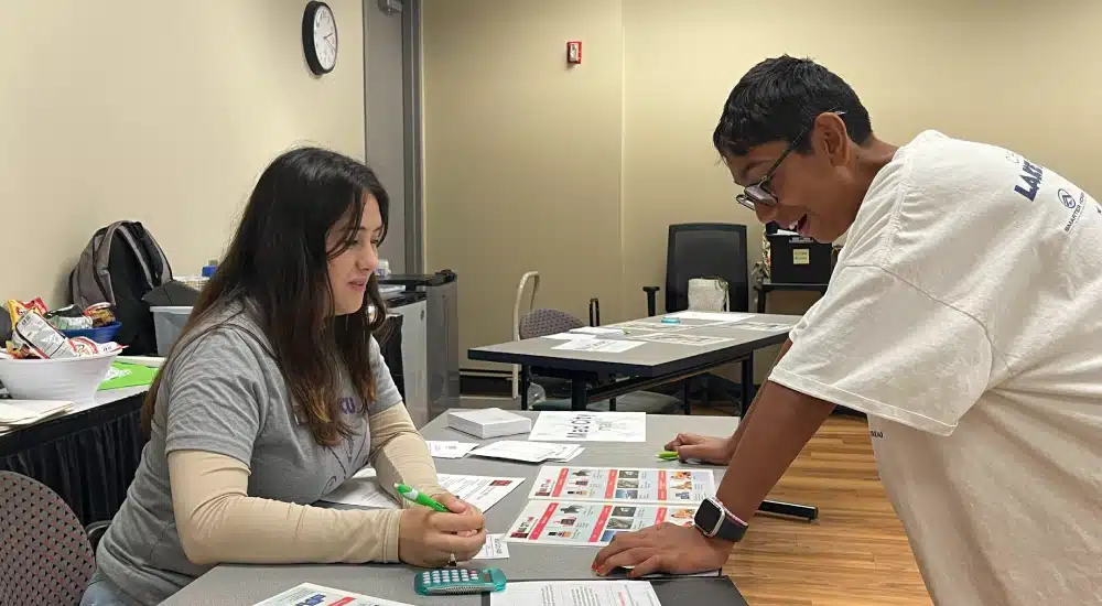Camper makes a purchase during a financial simulation