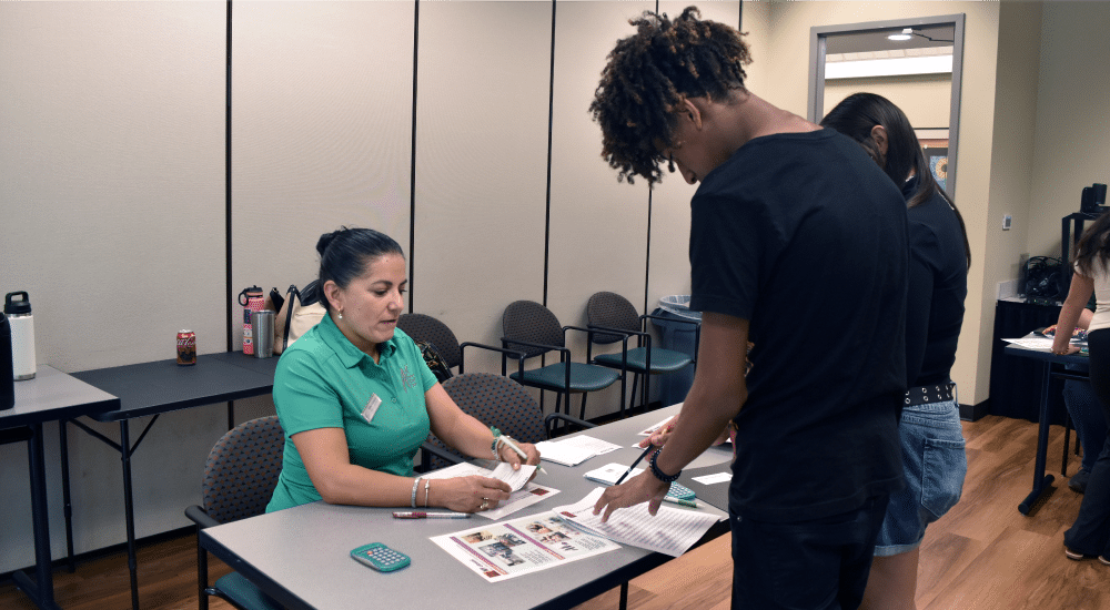 Camper buying household items during the Mad City Money budgeting simulation.