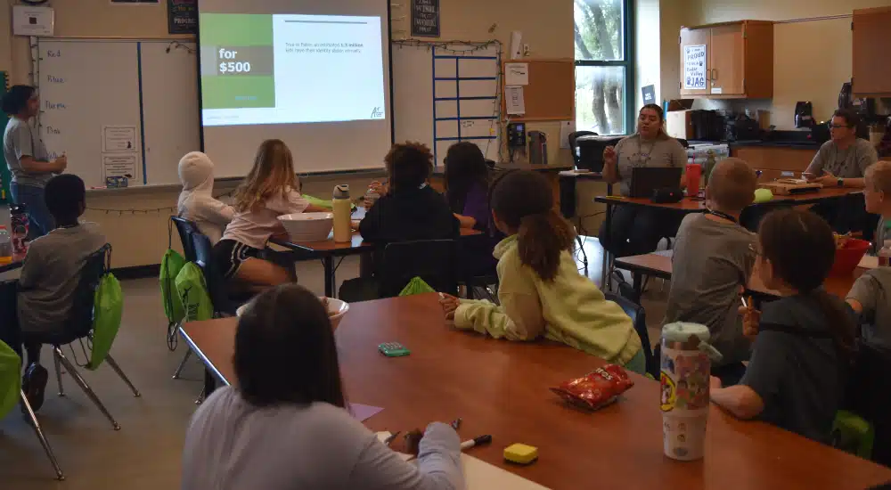 Campers play a team game to answer questions for camp cash.