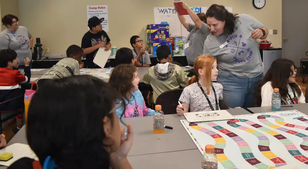 Campers play a board game.