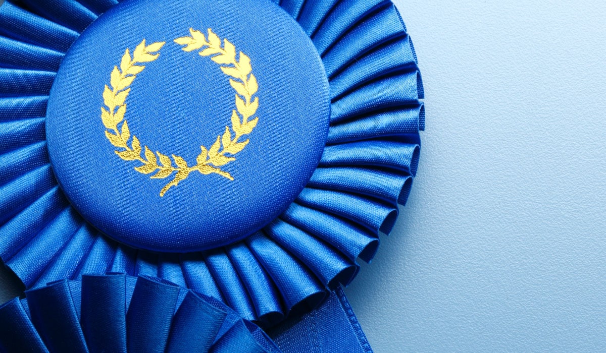 A photo of blue ribbons that look like awards.
